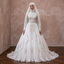 White ball gown wedding dress with long sleeves, embroidered panels, tiered skirt and headscarf