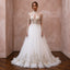 Tulle wedding dress with high neck, long sleeves, embroidered bodice, and full skirt