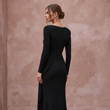 Black minimalist stretch jersey long sleeve ruched cocktail dress featuring a side ruffle detail.
