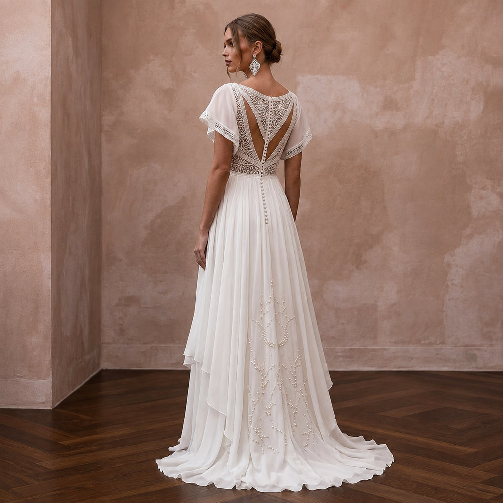 Ivory chiffon wedding dress with open back lace and flowing A-line skirt