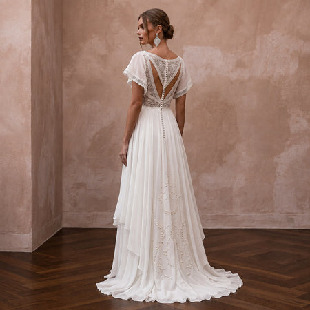 Ivory chiffon wedding dress with open back lace and flowing A-line skirt