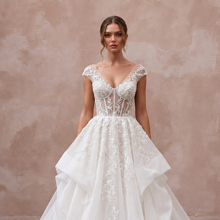 Elegant cathedral train organza wedding dress with intricate floral embroidery and a sheer bodice. Perfect for formal ceremonies.