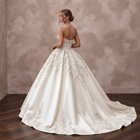 Elegant satin bridal gown with cathedral train, featuring intricate embroidery and a classic ball gown silhouette.