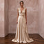 Champagne silk charmeuse maxi dress with plunging neckline and floral embroidery detail. Elegant and flowing design.