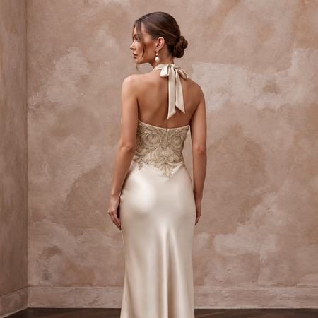 Champagne silk satin halter neck midi slip dress with beaded detailing, perfect for wedding guest attire.