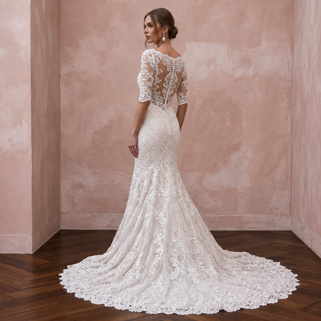 Elegant mermaid lace bridal dress with chapel train and sheer back, perfect for a church wedding.