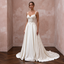 Elegant chapel train satin bridal dress with intricate embroidery, perfect for a vineyard wedding.