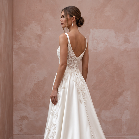 Elegant satin bridal dress with intricate embroidery, perfect for a vineyard wedding. Features a chapel train and back detail.