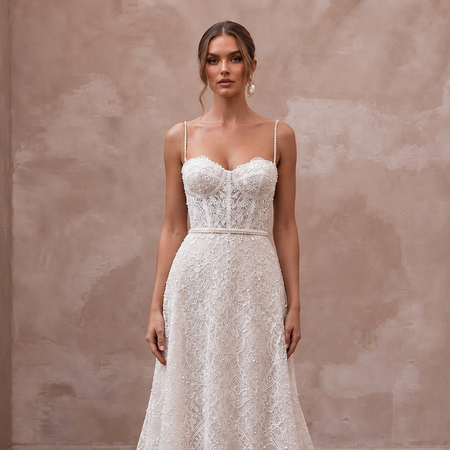 Elegant court train lace wedding gown with delicate beading, perfect for a civil ceremony. Features spaghetti straps.