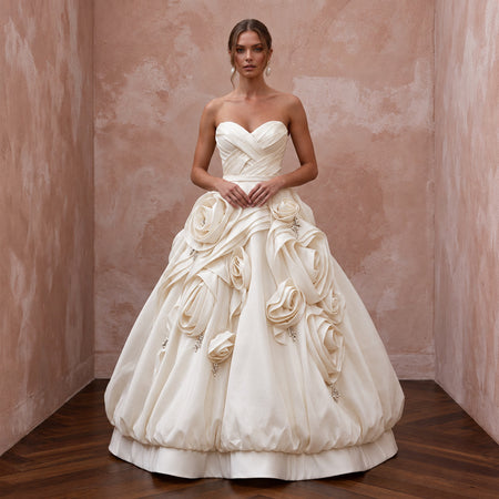 Cream satin face organza wedding gown with bubble skirt and rose details, featuring a strapless design.