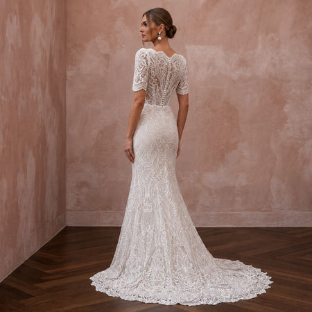 White lace back wedding dress with short sleeves and fitted mermaid silhouette