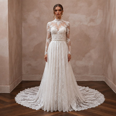 White lace wedding dress with long sleeves, high neckline, and full tiered skirt