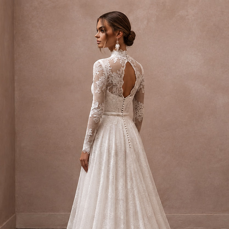 White lace wedding dress with long sleeves, open back lace panels, and lace buttons