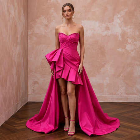 Fuchsia pink taffeta high-low hem strapless dress with ruffles, perfect for summer events. Elegant and stylish design.