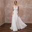 Halter neck chiffon bridal gown with elegant embroidery, perfect for beach weddings. Flowing skirt and chic design.
