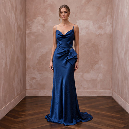 Elegant midnight blue silk charmeuse cowl neck slip dress with draped detail, perfect for a gala.