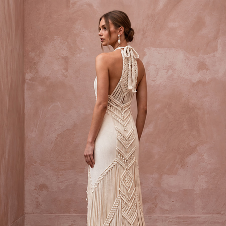 Minimalist cream cotton macrame fringe halter dress, perfect for a desert bridal look. Elegant and stylish design.