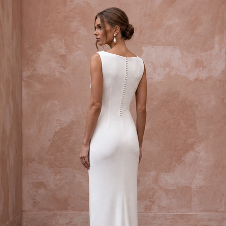 Minimalist pure white stretch cotton ribbed knit column gown with button detail, perfect for elegant occasions.