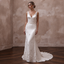 White satin sheath wedding dress with V-neck bodice, floral beading, and long train
