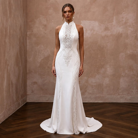 White high-neck wedding sheath dress with geometric lace embroidery and sleeveless cut