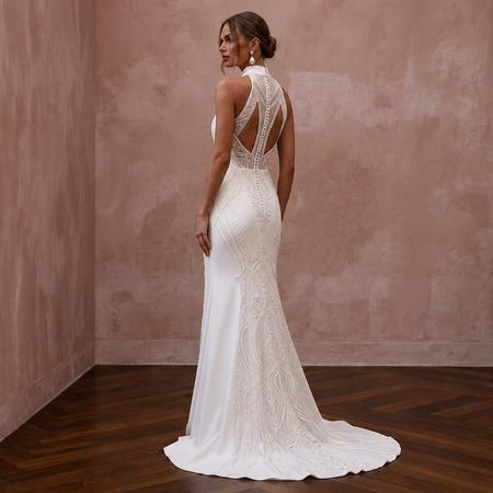 White wedding sheath dress with open back and lace embroidery, floor-length train