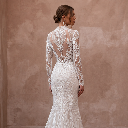White lace mermaid wedding dress with long sheer sleeves and detailed back panel