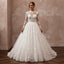 Ivory lace wedding dress with long sleeves, illusion neckline, and ballgown skirt