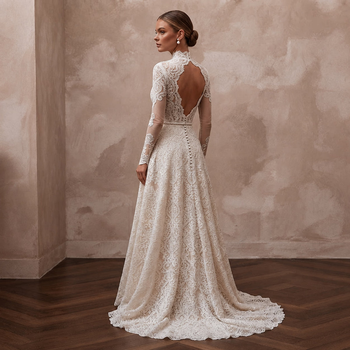 Lace bridal gown with long sleeves, open back lace detail and flowing A-line skirt