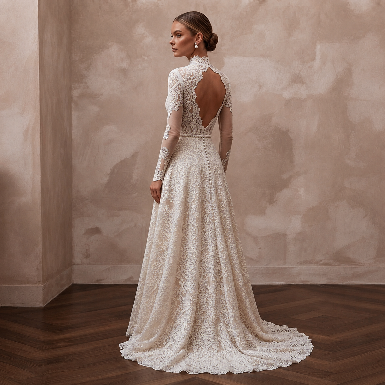 Lace bridal gown with long sleeves, open back lace detail and flowing A-line skirt