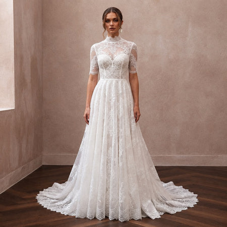 White lace wedding dress with high neck and full A-line tulle skirt, short lace sleeves