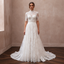 White lace wedding dress with high neck and full A-line tulle skirt, short lace sleeves