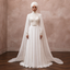 White high-neck wedding dress with lace bodice and flowing chiffon cape veil