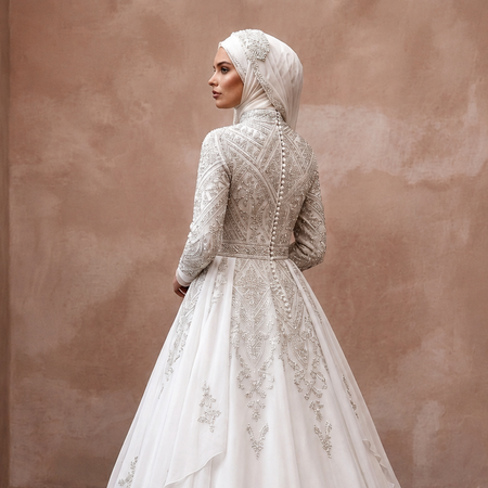White long-sleeve wedding dress with embroidered back and bodice, flowing ball gown skirt