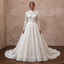 White lace A-line wedding dress with long sleeves, high neckline, and flowing skirt