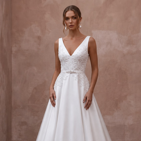 White sleeveless V-neck wedding dress with embroidered bodice and A-line silhouette