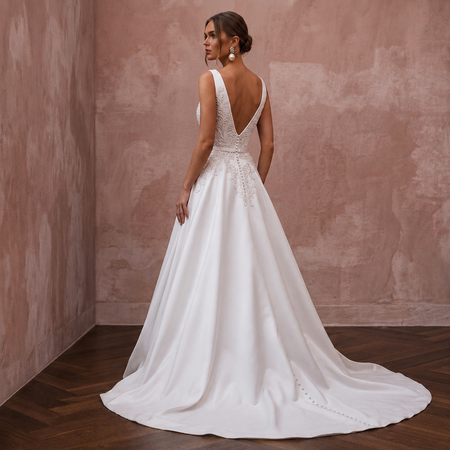 White sleeveless satin wedding dress with open back V-neck and A-line skirt