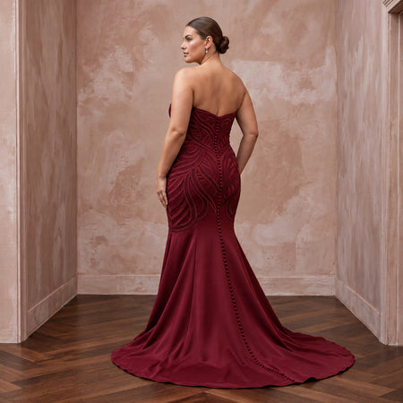 Plus size burgundy heavy matte satin sweetheart mermaid dress with intricate detailing and a flowing train.