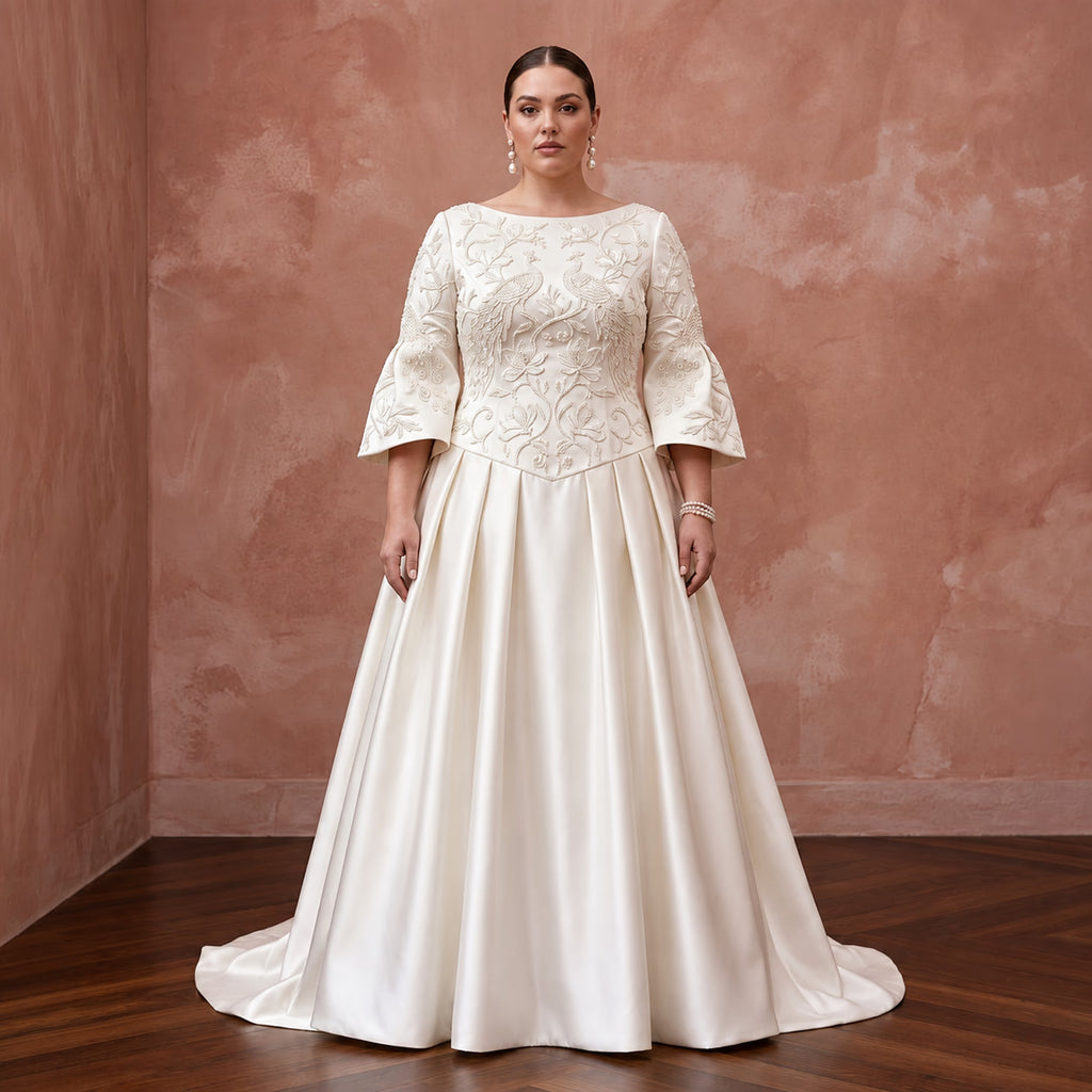 Plus size ivory duchess satin drop waist dress with embroidered bodice and bell sleeves, perfect for grandmillennial style.