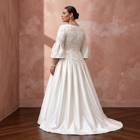 Plus size ivory duchess satin dress with embroidered bodice and drop waist, featuring flared sleeves and a full skirt.
