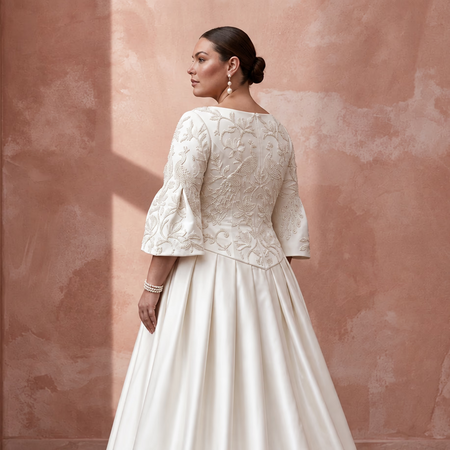 Plus size ivory duchess satin drop waist dress with intricate embroidered detailing and bell sleeves.