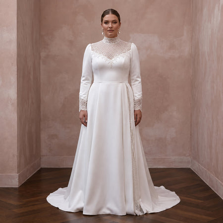 White satin wedding dress with lace high neckline, long sleeves, and back drape train