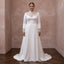 White satin wedding dress with lace high neckline, long sleeves, and back drape train