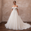 Ivory off-shoulder lace tulle ball gown wedding dress with gathered waist and full train