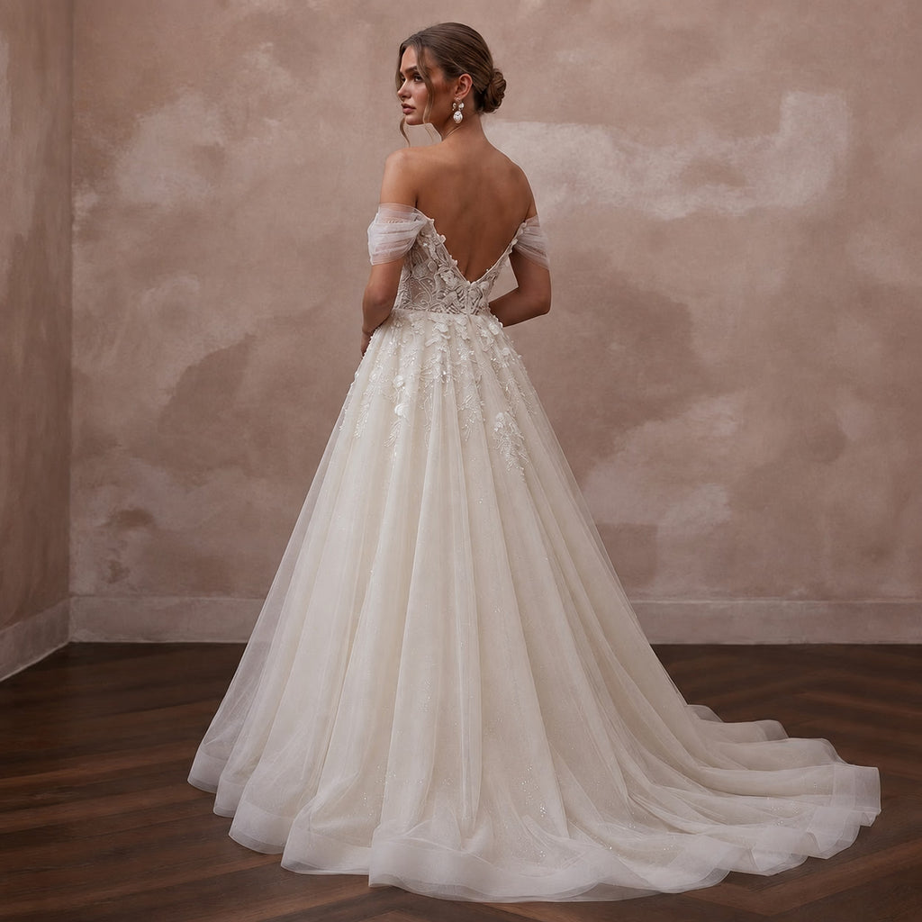 Ivory off-shoulder tulle ball gown wedding dress with lace appliques and full skirt