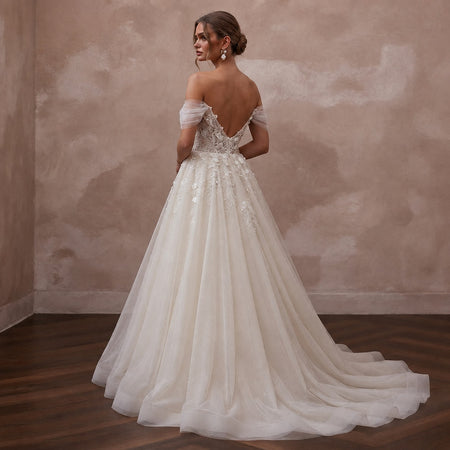 Ivory off-shoulder tulle ball gown wedding dress with lace appliques and full skirt