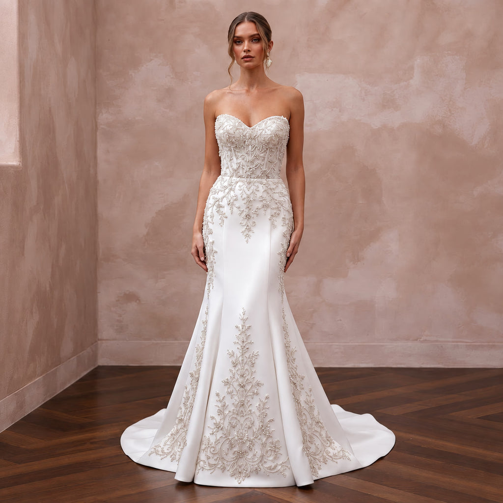 Elegant pure white matte satin wedding dress with a dropped waist and intricate beaded embroidery.