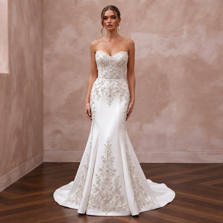 Elegant pure white matte satin wedding dress with a dropped waist and intricate beaded embroidery.