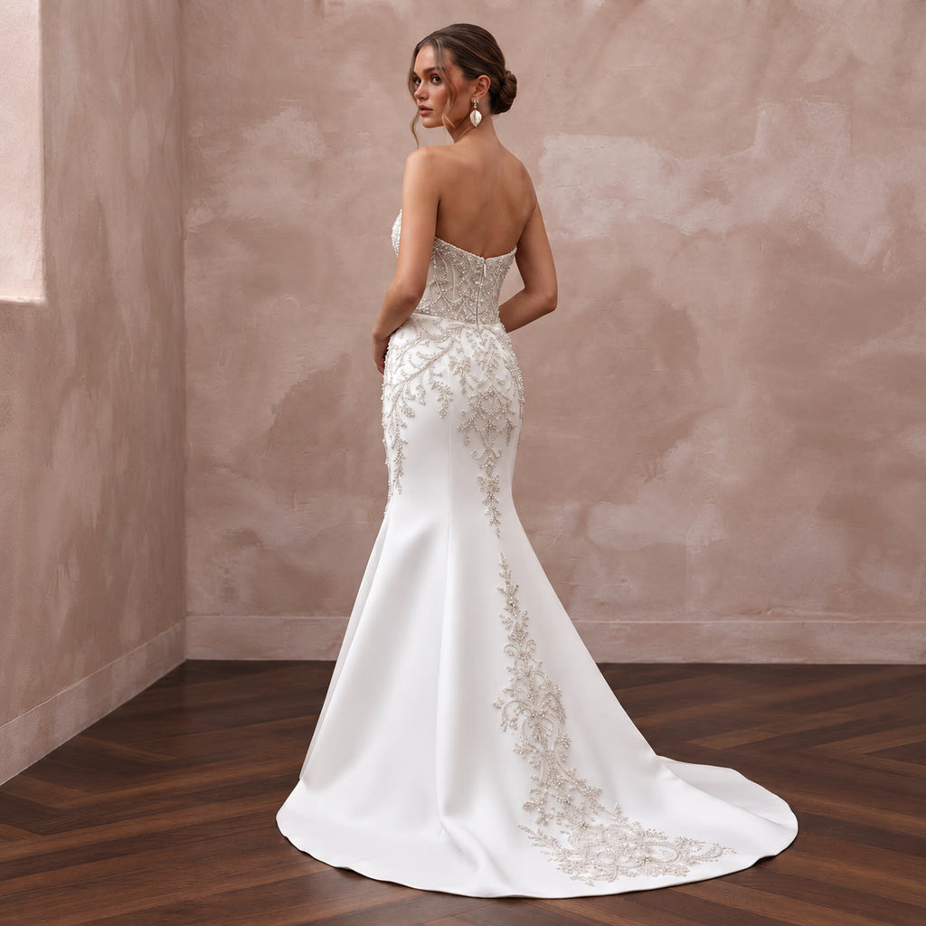 Elegant pure white matte satin trumpet wedding dress with dropped waist and intricate beaded embroidery.