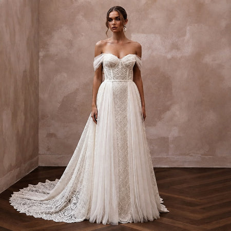 Ivory off-the-shoulder lace bridal gown with layered tulle skirt and detachable train