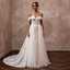 Ivory off-the-shoulder lace bridal gown with layered tulle skirt and detachable train